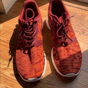 Nike red/orange Aztec sneakers.